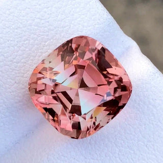 Sunset tourmaline gemstones displaying a radiant gradient of pink, orange, and golden hues - capturing the natural beauty and vibrant colors reminiscent of a sunset.