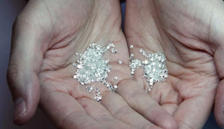 A close-up of a small certified diamond under magnification, showcasing the precision and quality of the certification.