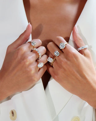 Moissanite and diamond rings placed side by side on a velvet tray, highlighting their brilliance and differences in a luxury setting. 