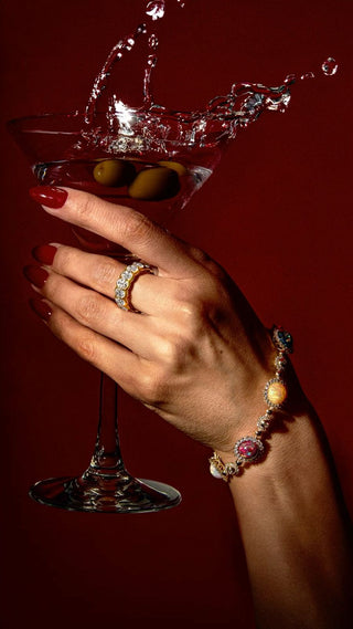 A dazzling engagement ring catching the light at a festive holiday party, symbolizing seasonal sparkle and care.