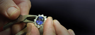 A calendar marked with jewelry checkup reminders, next to a cleaning kit and a diamond ring, emphasizing annual maintenance.