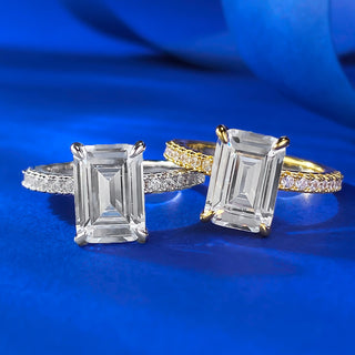 Sterling silver ring with an emerald-cut moissanite centerpiece in a classic prong setting, showcasing minimalist elegance.