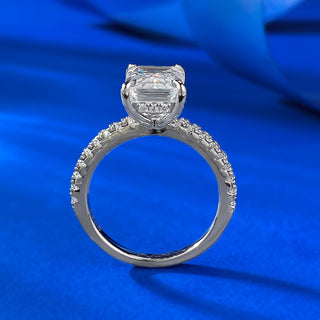 Sterling silver ring with an emerald-cut moissanite centerpiece in a classic prong setting, showcasing minimalist elegance.
