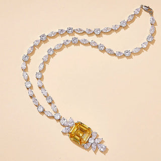 Gold-fused sterling alloy necklace featuring a central yellow lab-created sapphire framed by white sapphires, evoking regal vintage elegance.