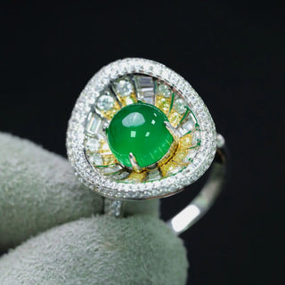 Sterling silver sunburst ring featuring a central jade stone with radiating yellow and white lab sapphires in a vibrant, green statement design.