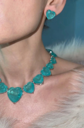 Heart of Ocean Necklace and earrings set with sea-blue crystal hearts in silver-copper blend, inspired by ocean depths and timeless romance.

