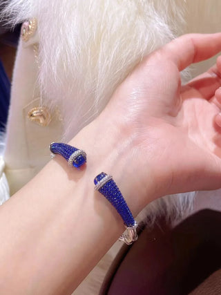 Silver Sapphire Mirage Bangle featuring lab sapphires in a polished silver finish – elegant sapphire bangle bracelet by Azzallure.