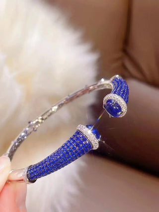 Silver Sapphire Mirage Bangle featuring lab sapphires in a polished silver finish – elegant sapphire bangle bracelet by Azzallure.