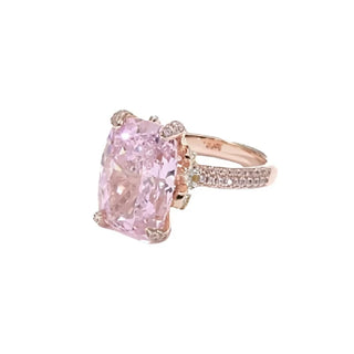 The Garden of Aurora Ring featuring an 8-carat pink lab-created sapphire in a rose gold setting, surrounded by sparkling lab sapphires. A symbol of love and new beginnings.

