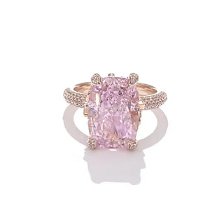 The Garden of Aurora Ring featuring an 8-carat pink lab-created sapphire in a rose gold setting, surrounded by sparkling lab sapphires. A symbol of love and new beginnings.


