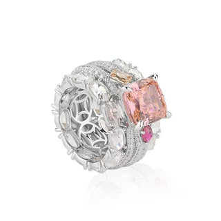 Bold sterling silver cocktail ring featuring a radiant pink lab sapphire center with pavé-set accents, designed for glamorous statement wear.
